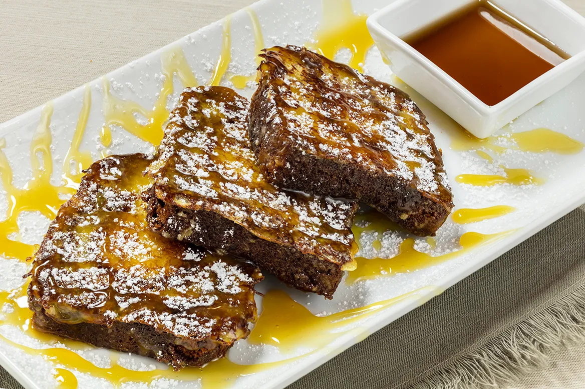 Pound Cake French Toast — three slices of cinnamon swirl pound cake with a butterscotch drizzle and powdered sugar