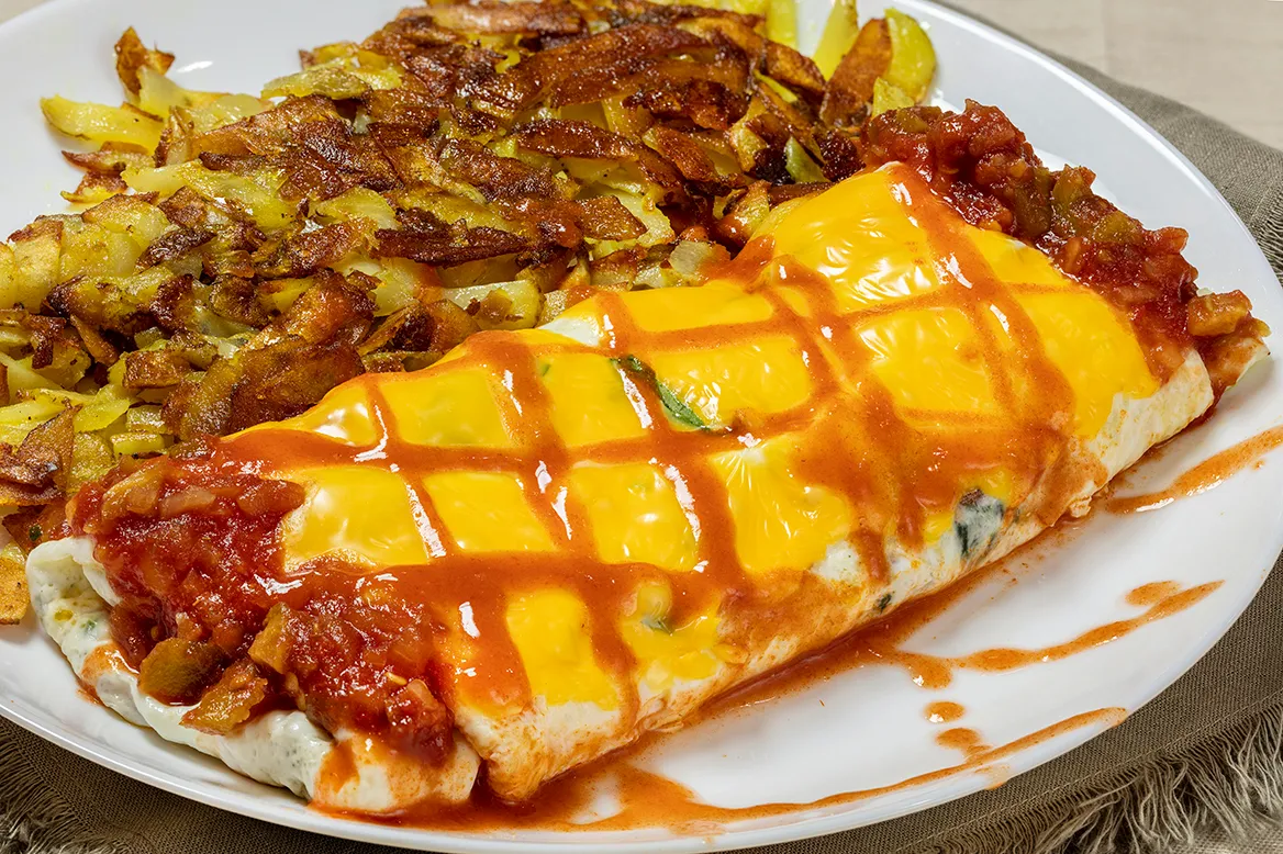 Davezilla — egg white omelet with spinach and melted American cheese, finished with red salsa and buffalo sauce