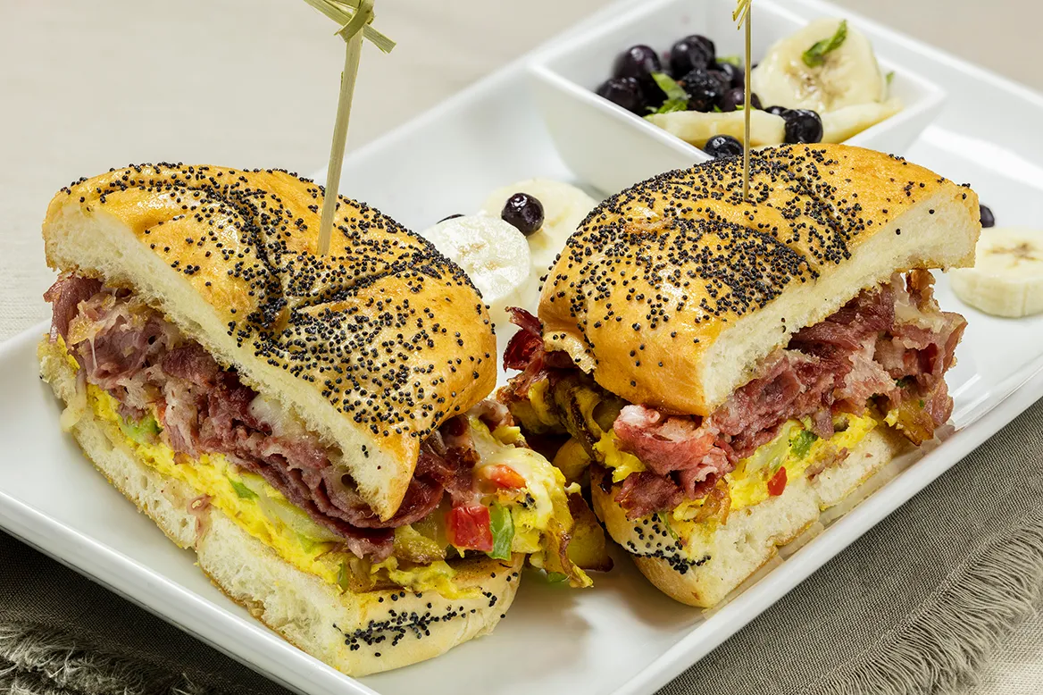 Hash Backwards — scrambled eggs, potatoes, peppers, corned beef and Jack cheese on a grilled poppyseed Kaiser roll